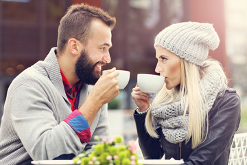 Happy adult couple dating in cafe