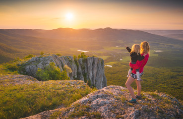 Mother with child and sunset