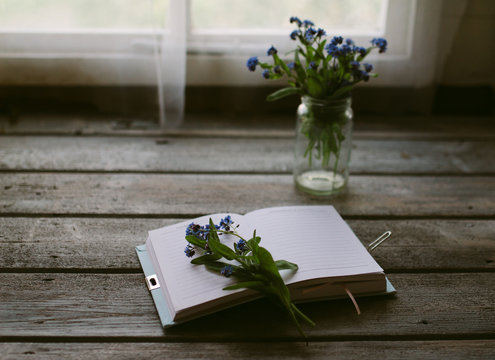 Forget me not flowers on the open page of a journal