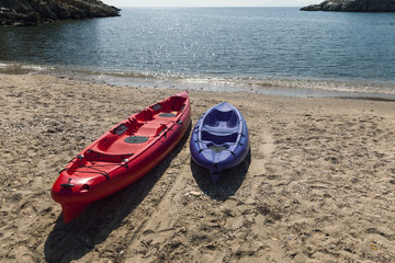 two plastic kayak on beach