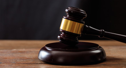 Judge or auction gavel on a wooden desk