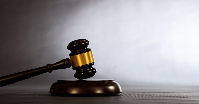 Judge or auction gavel on a dark background