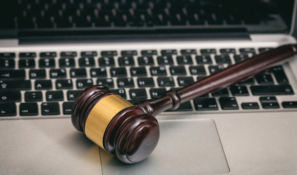 Auction or Judge gavel on a laptop