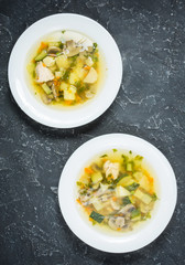 Soup with Mushrooms and chicken on stone background, top view
