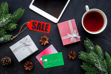 order new year 2018 present with sale with credit card and device on black table background top view mock up