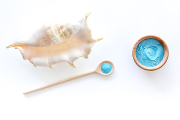 spa set with blue sea salt for bath and shell white background top view mockup
