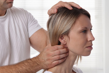 Naklejka premium Chiropractic adjustment, Osteopathy. Female patient suffering from back and neck pain and physical therapist