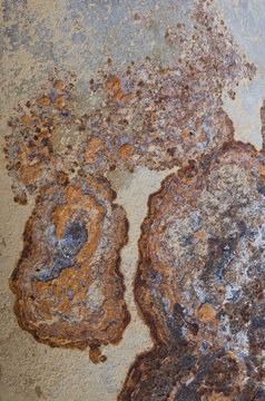 closeup macro macrophotograph rust patterns on base of lamppost lamp post light post