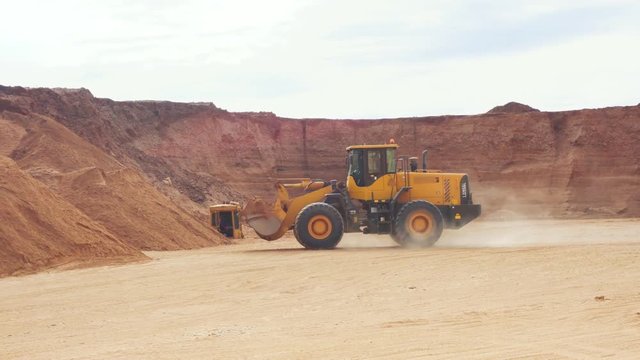 front loader goes with the sand in the career