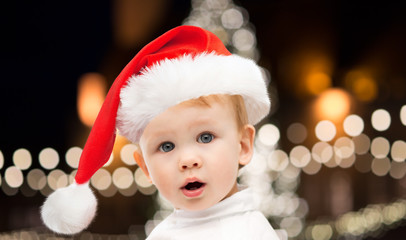 little baby boy in santa hat at christmas