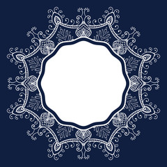 decorative round openwork frame in the form of a snowflake, template for design on a dark blue background