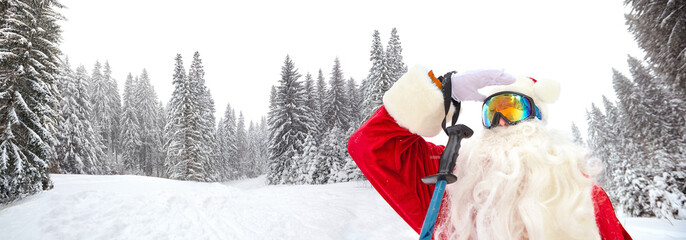 Santa Claus skier on the background of the ski landscape. Rest on Christmas in the mountains.