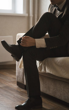 Man tightening a shoe-lace