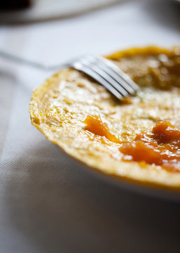 Eating homemade omelette with apricot jam