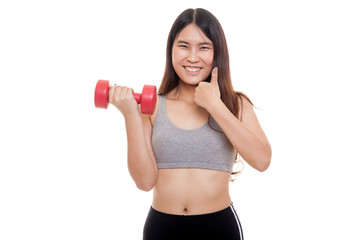 Beautiful Asian healthy girl thumbs up with dumbbell.