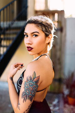 Beautiful hispanic woman looking over her shoulder