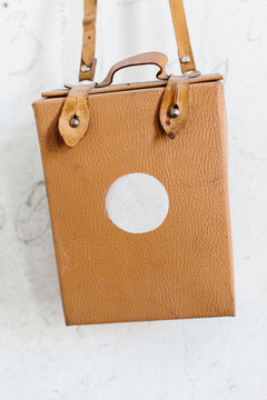 Portable first aid kit hanging on white wall