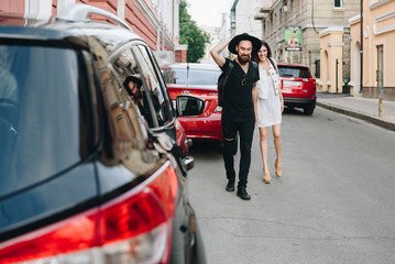 Couple having fun outdoors. Guy and girl walking in the city. Street love. Man in black. girl in white.