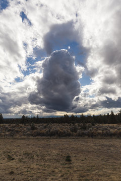 Dramatic Clouds Over Desert Landscape