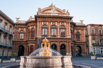 Fototapeta na wymiar Landmarks of Catania: night view of the fountain of Dolphins in Piazza teatro Massimo, and a view of the Bellini theater
