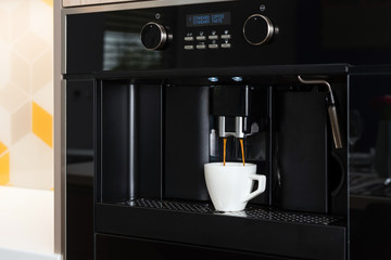 Detail of built-in coffee machine in contemporary kitchen