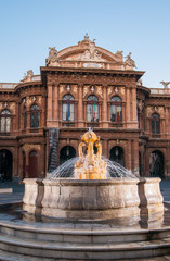 Fototapeta na wymiar Landmarks of Catania: night view of the fountain of Dolphins in Piazza teatro Massimo, and a view of the Bellini theater