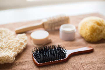 hair brush, cream, sponge, soap bar and bath towel
