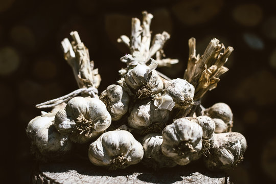 Closeup of a bunch of garlic on a trunk.