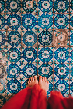 Woman Barefoot Standing On Aged Tiles Floor