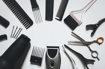 Hair stylist's accessories on a white background top view copy space. Hairdressing skill. Barbershop concept.