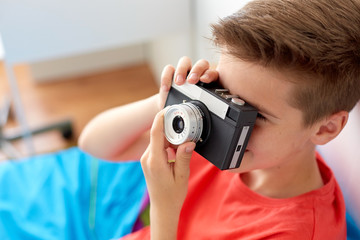 close up of boy photographing by film camera