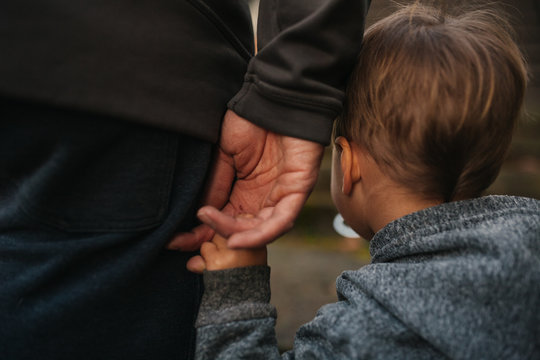 Cute little boy holding dad's hand