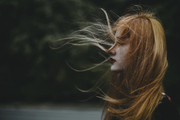 Young woman with hair blowing in the wind 