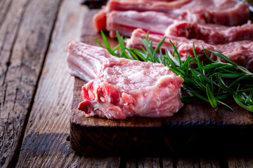 Raw fresh meat Veal rib Steak on bone  on a wooden vintage background with spices and rosemary
