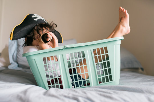 scruffy young pirate in his laundry basket boat