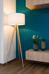 Lamp and vases on cabinet, blue wall in background