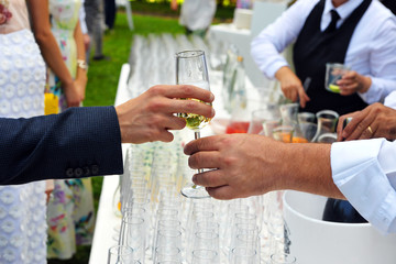 Pass the glass of Champagne. Party. Catering. Hand