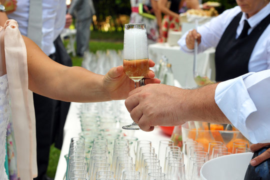 Pass the glass of Champagne. Party. Catering. Hand