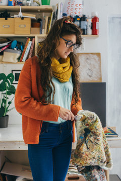 Young Female Painter Cleaning Paint Brush in Atelier