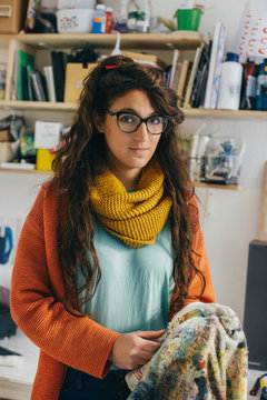 Indoor Portrait of Young Female Painter Holding Paint Brush and Rag