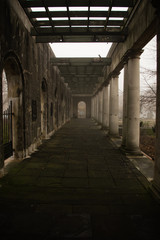 Stone column relics at Birmingham Peace Garden on a misty morning