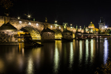 Fototapeta na wymiar Karl´s bridge in the capital city of Czech republic, Prague. Night view on lights reflection in river Vltava.