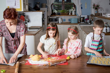 Family baking, Mother and kids in the kitchen making cakes