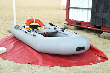 Inflatable Rescue Boat. Gray inflatable boat on the beach in the sand