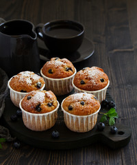Oat muffins with blueberries on a dark background.