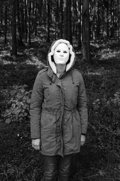 Someone standing suspiciously wearing a mask.