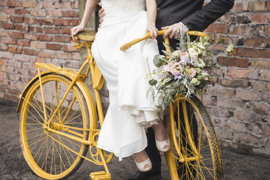Couple with Yellow Bike on Their Wedding Day