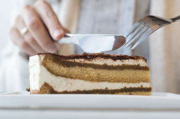 Close Up Shot Of Womans Hand Slicing Cake