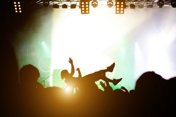 Stage diving. Crowd surfing during a musical performance