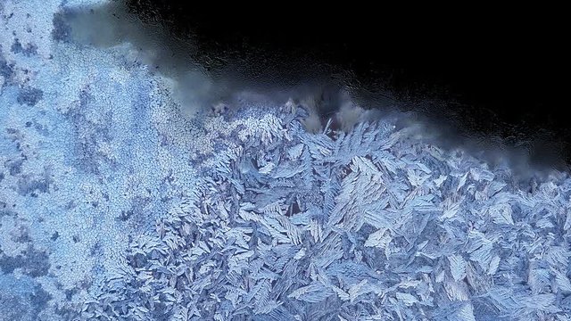 Beautiful frozen window melting animation from top to bottom, timelapse defrost transition, natural dissolve, isolated on black background with black and white luminance matte, alpha channel.